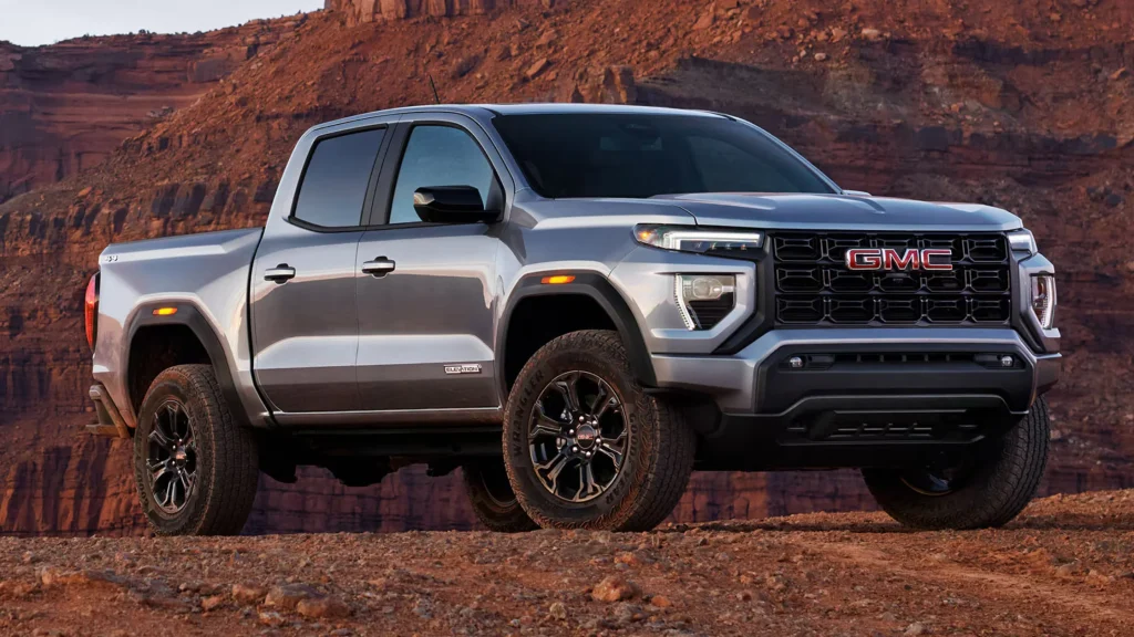 2025 GMC Canyon Elevation Edition parked off-road against a red rock canyon backdrop.