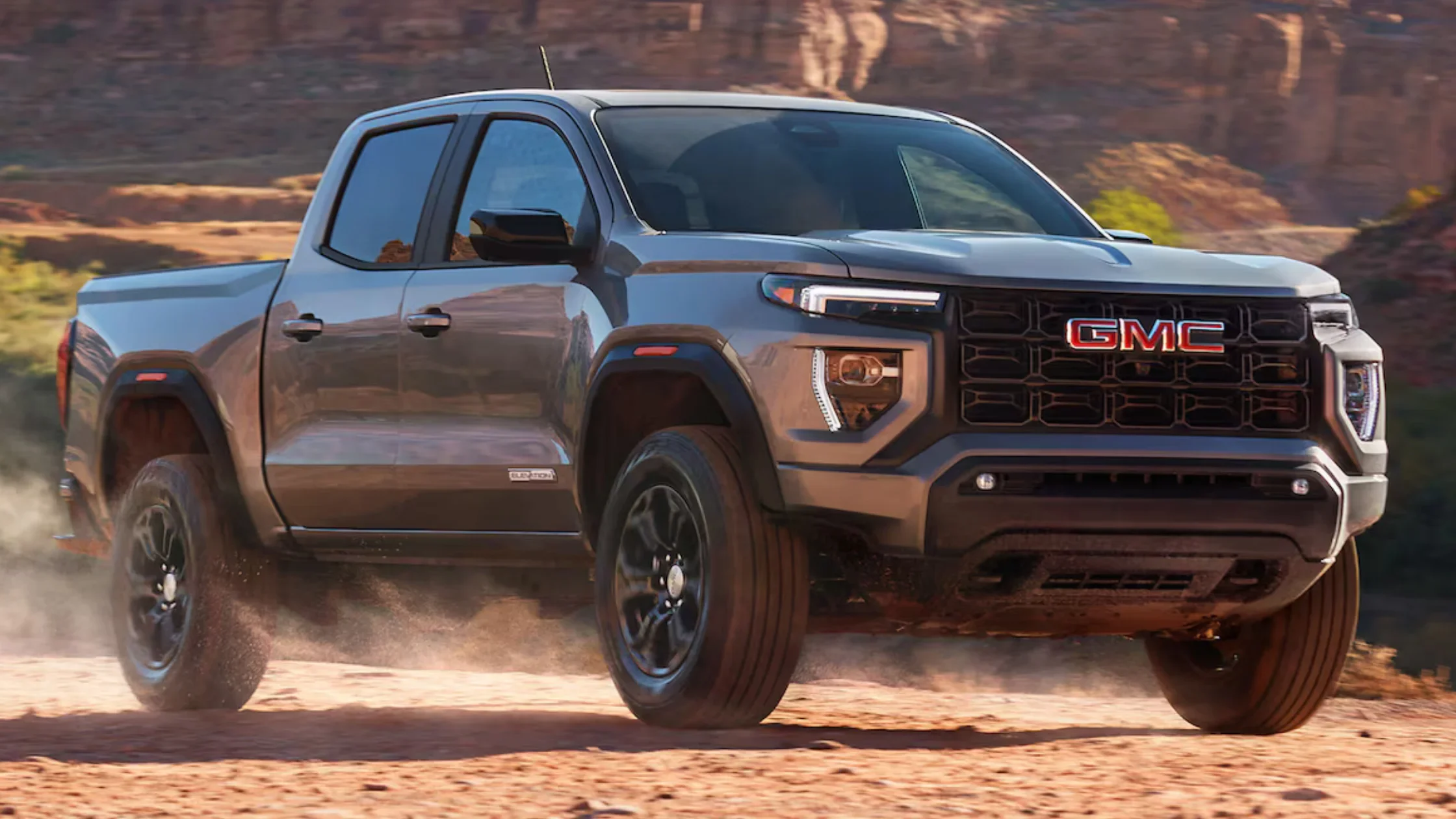 2025 GMC Canyon mid-size pickup truck in motion on dirt trail near Dickson, TN