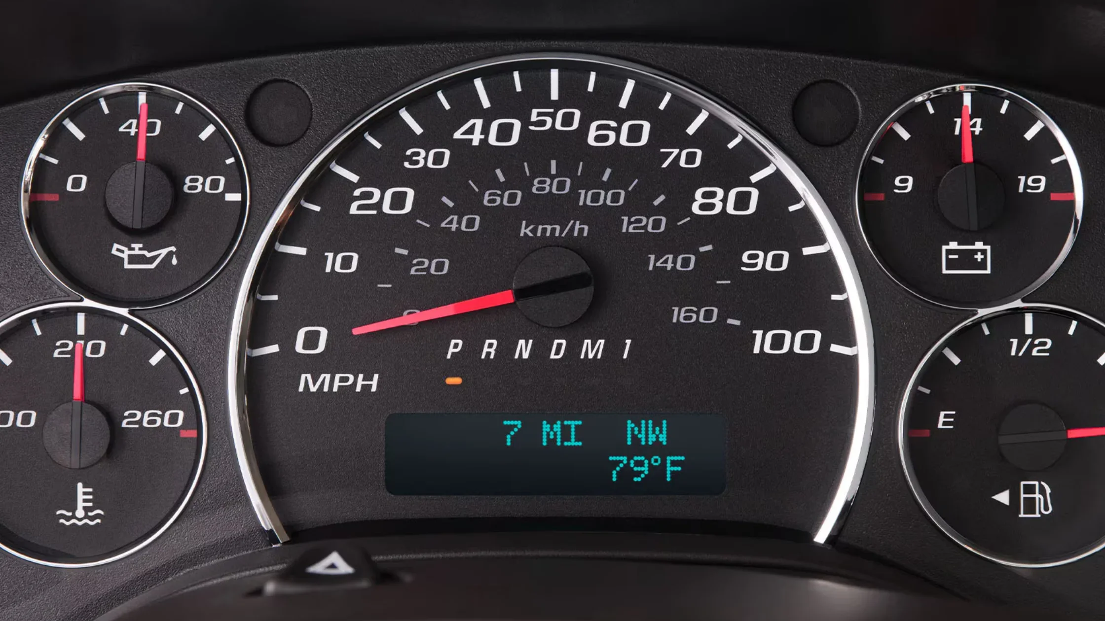 Close-up of the Savana’s analog speedometer cluster and gauges, showing mileage, compass, and fuel readout.