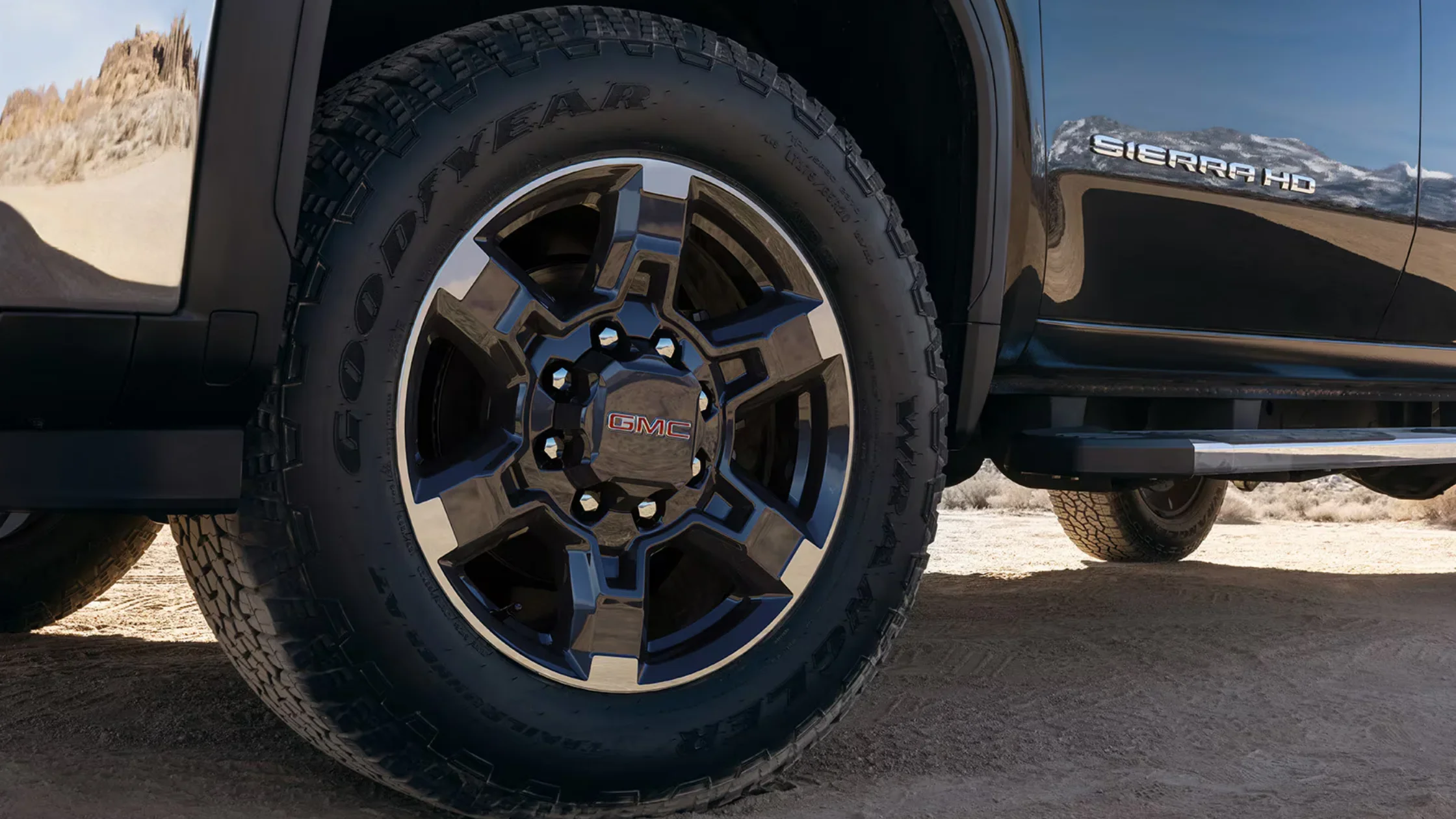 Close-up of Goodyear Wrangler tire and black alloy wheel on 2025 GMC Sierra 3500 HD.