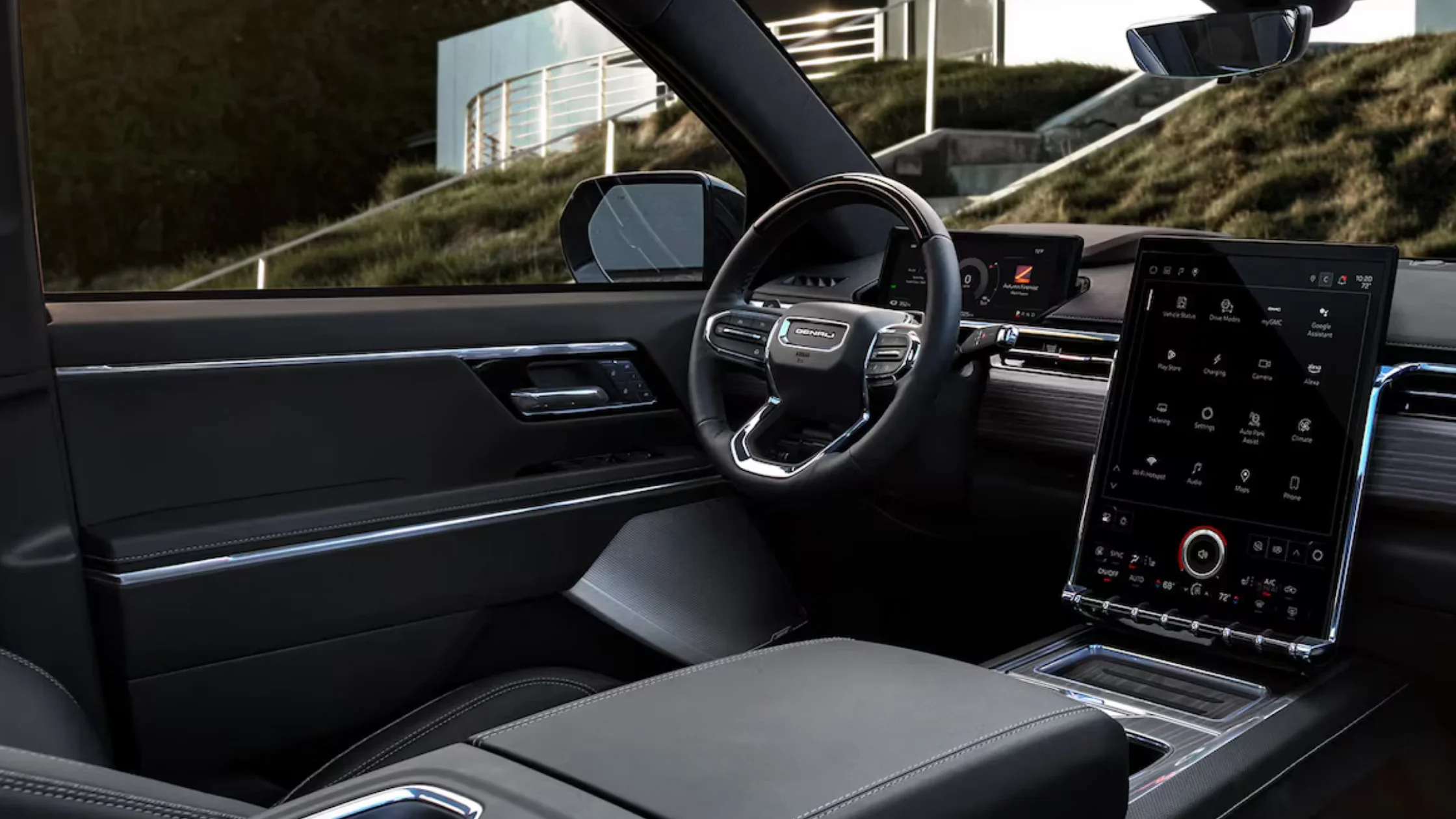 Driver cockpit of 2025 GMC Sierra EV Denali Edition 1 showing vertical infotainment display.