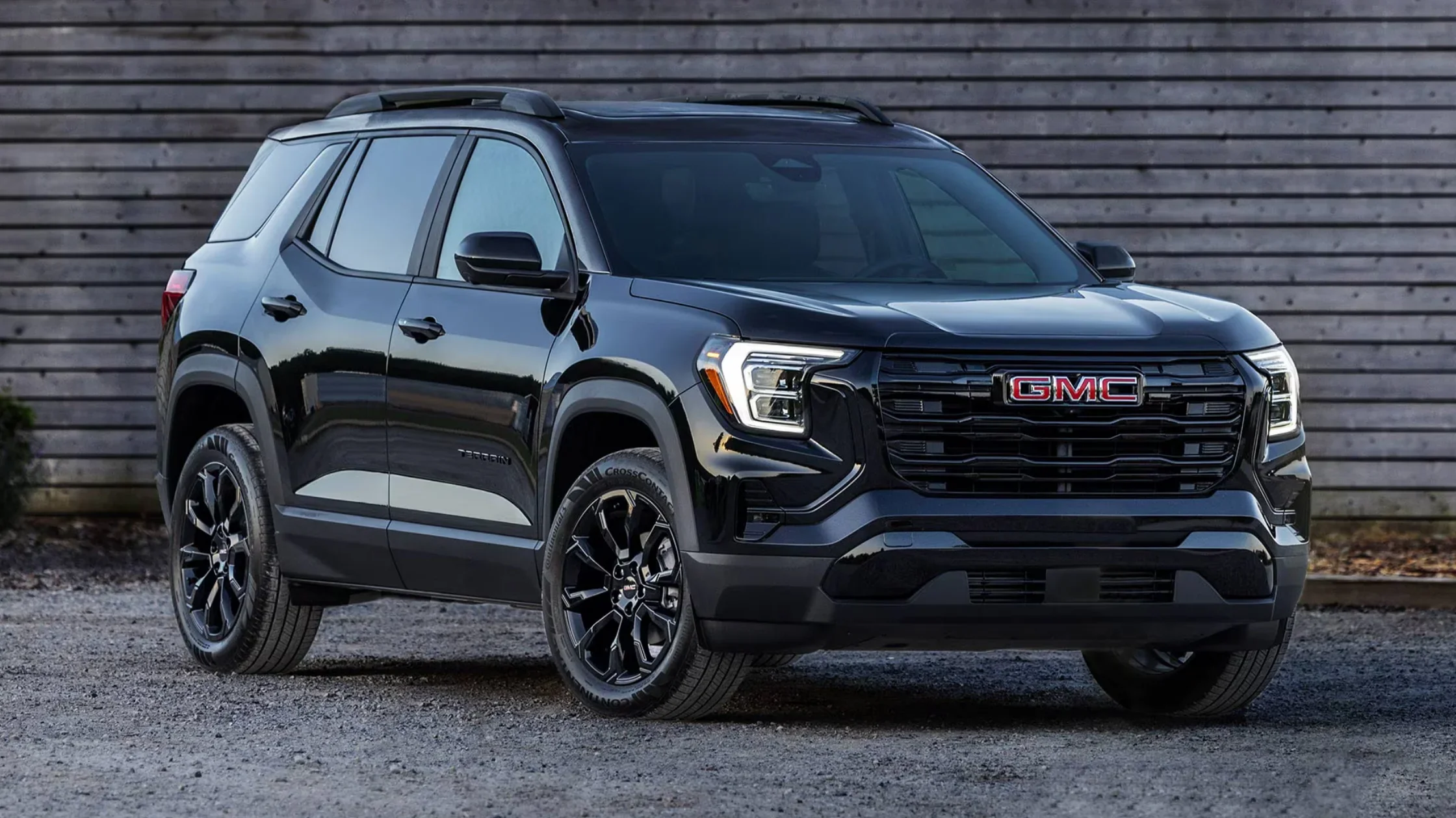 Front three-quarter view of 2025 GMC Terrain AT4 in black with signature LED lighting and black trim.