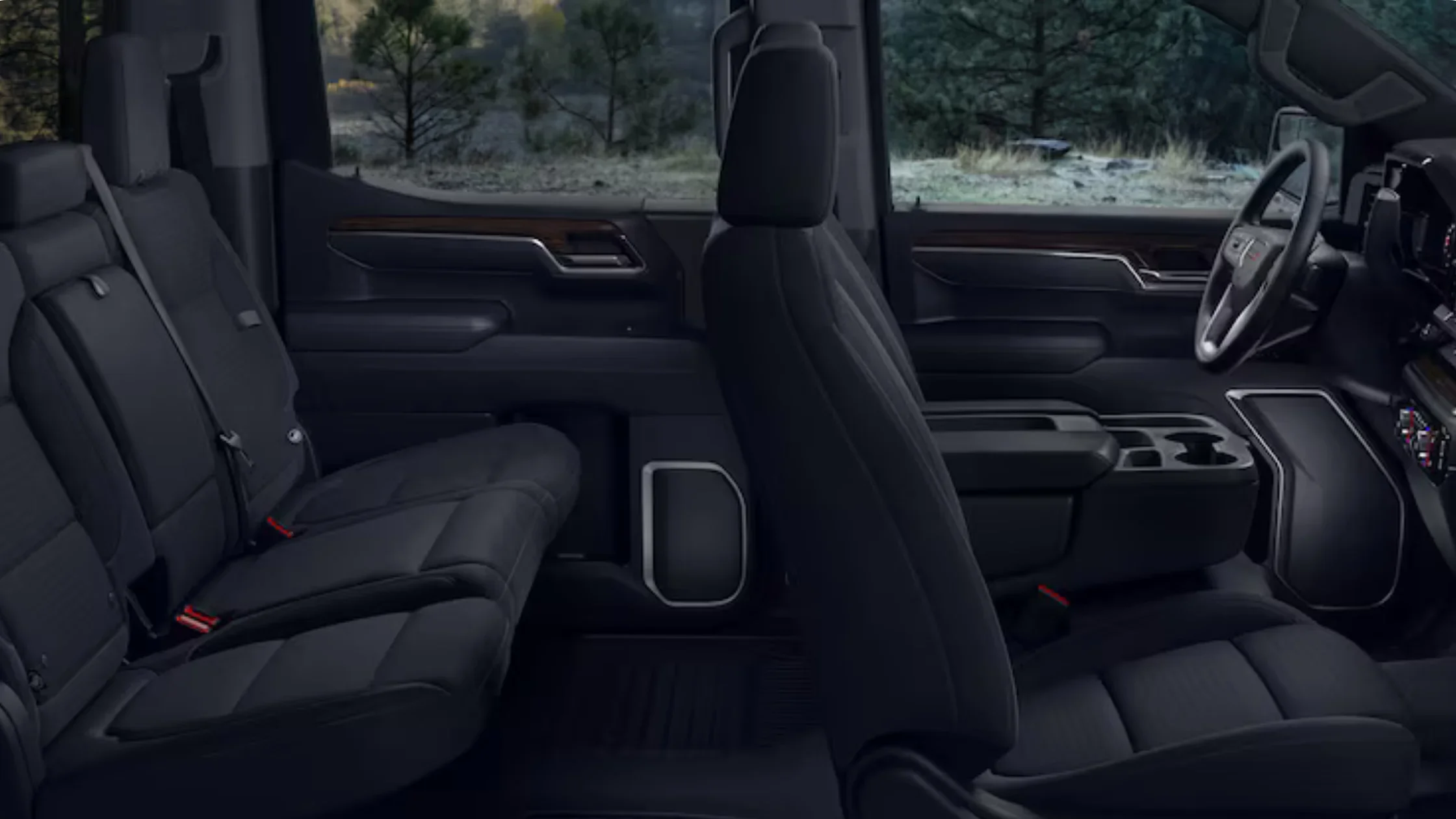 Side profile view of 2026 GMC Sierra 1500 interior showing spacious cabin and premium black seats.