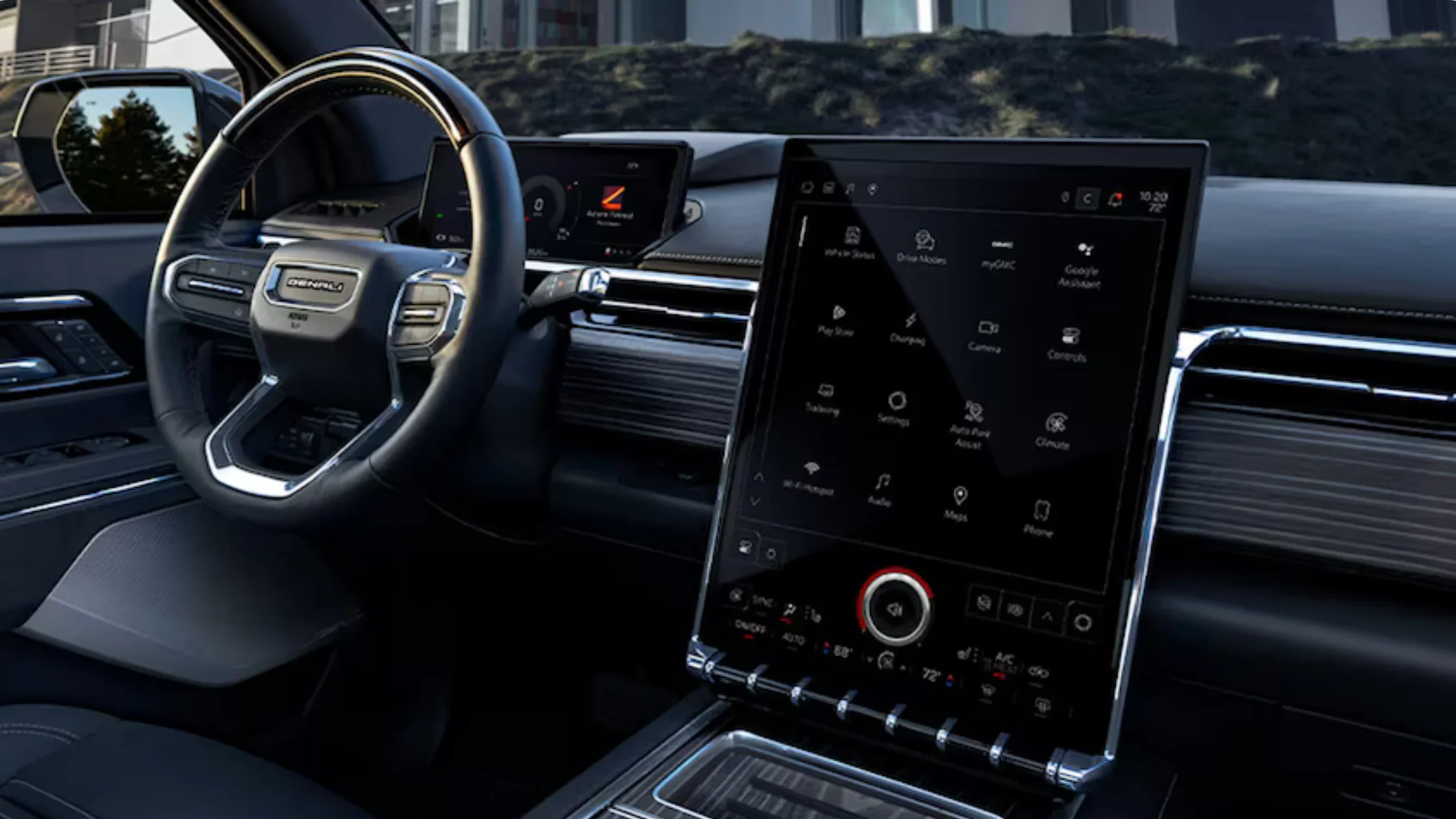 Close-up of 2026 Sierra EV Denali steering wheel and vertical infotainment touchscreen.